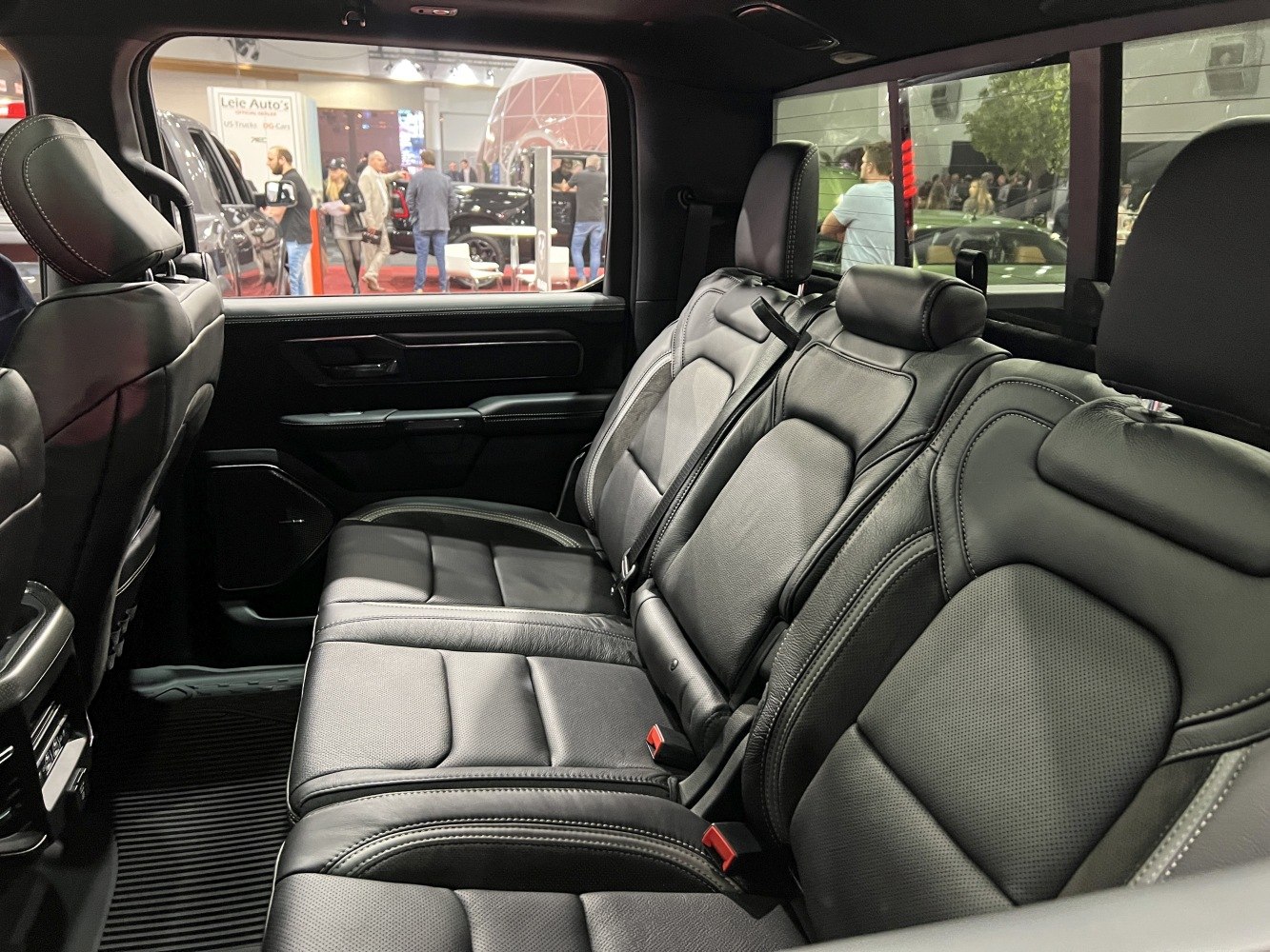 Spacious premium black leather rear seats in truck cabin
