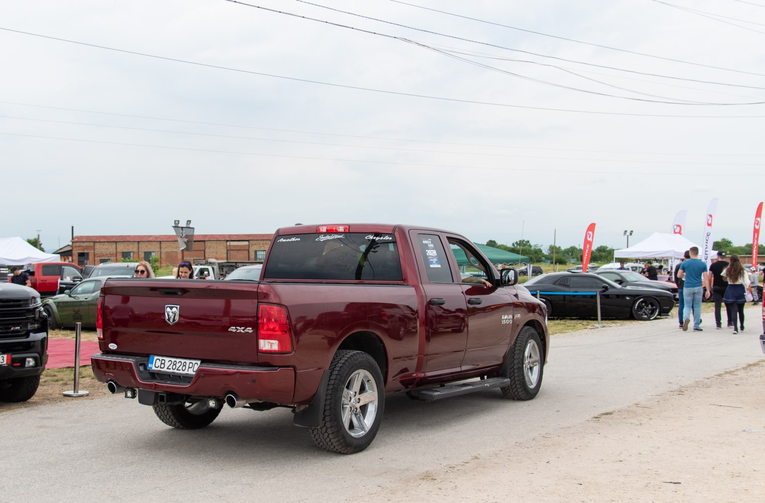 Rear view of 4x4 pickup with dual exhaust and step bar