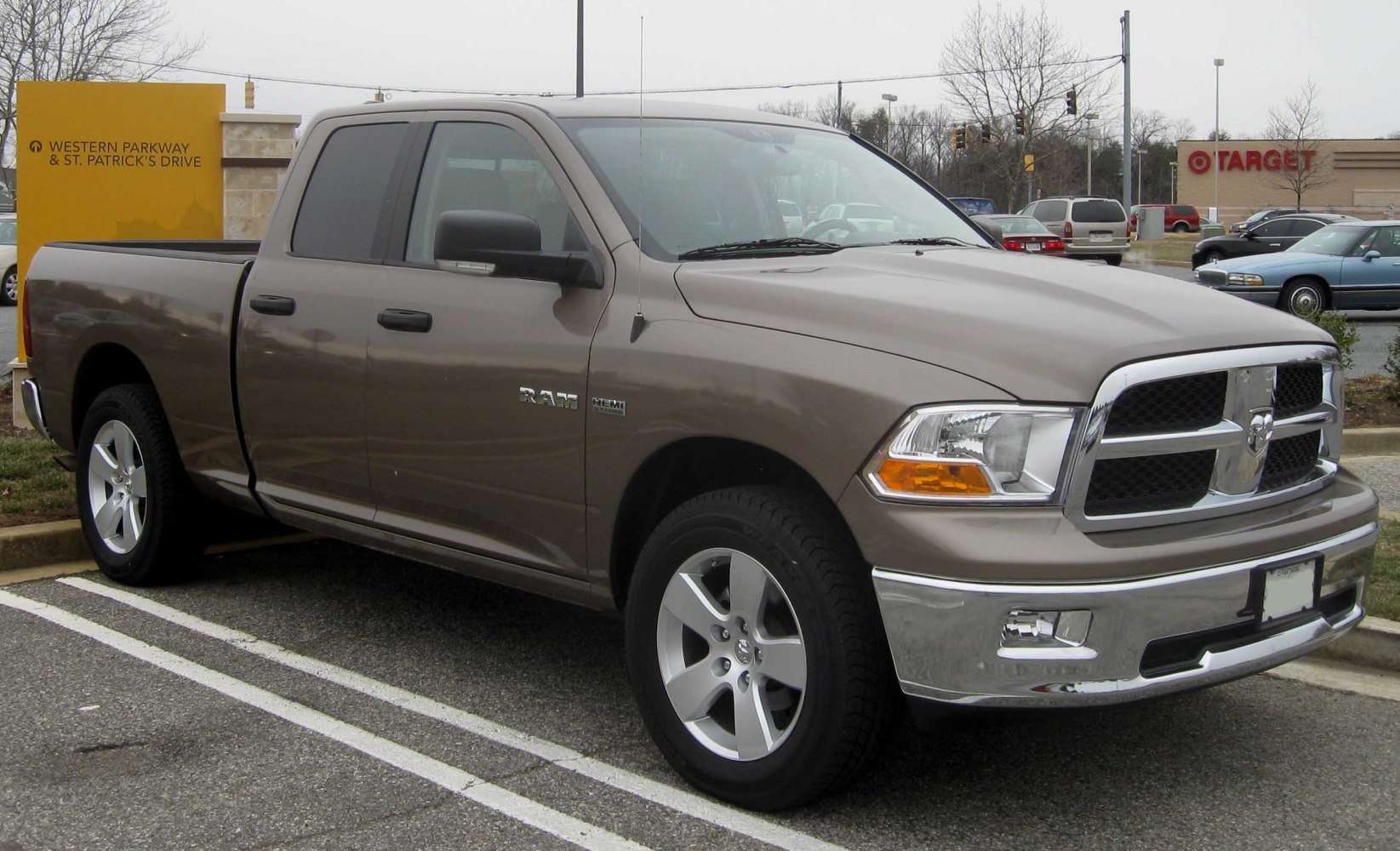 Front side view of Quad Cab pickup with HEMI badge and chrome grille
