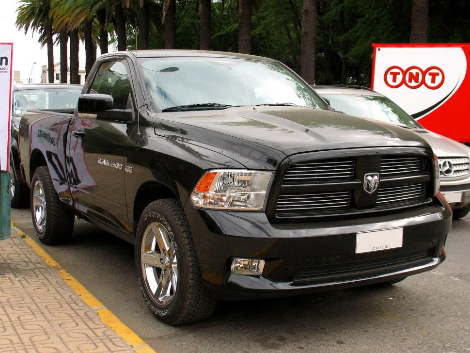 Black pickup truck front view with chrome wheels and distinctive grille