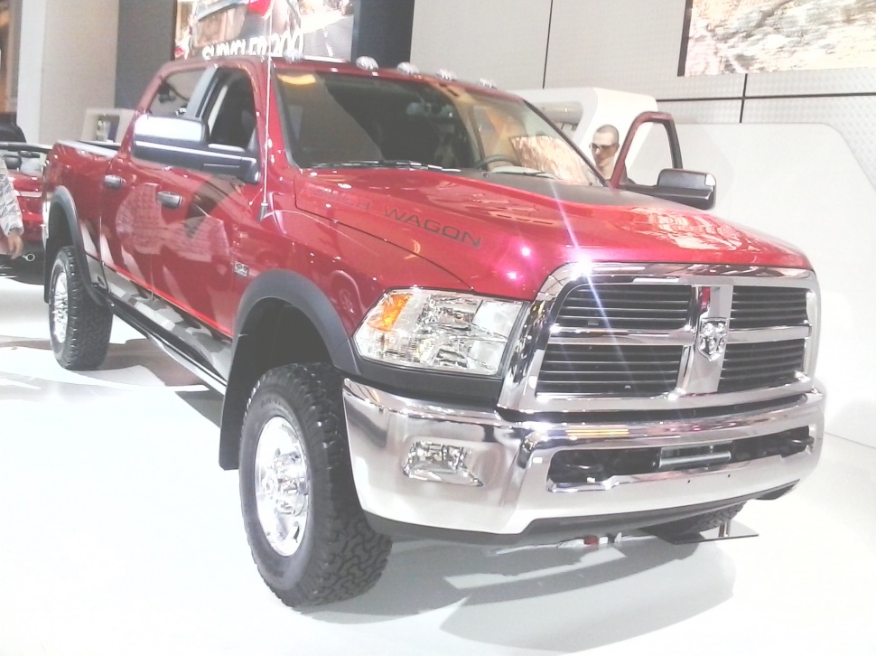 Front grille and headlights of a heavy-duty pickup with off-road tires.
