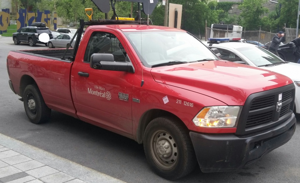 Red full-size pickup truck with regular cab and utility bed setup
