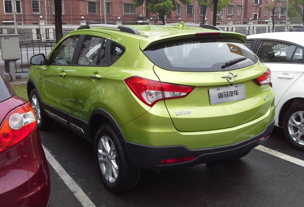Rear and side view of a green SUV with modern taillights and roof rails