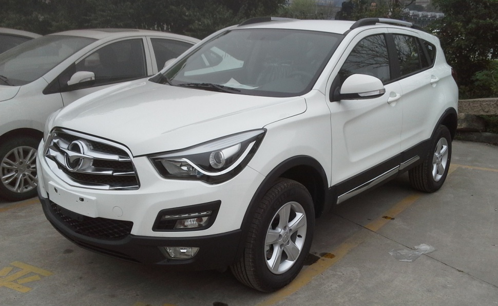Front and side view of white SUV with distinct headlights and grille design