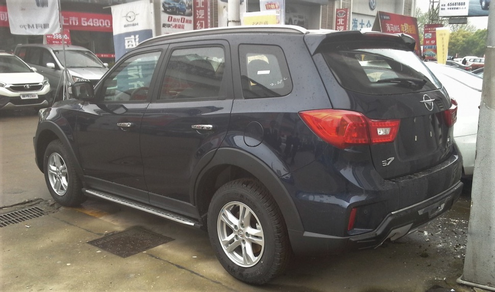 Rear and side view of dark blue SUV with alloy wheels and modern taillights