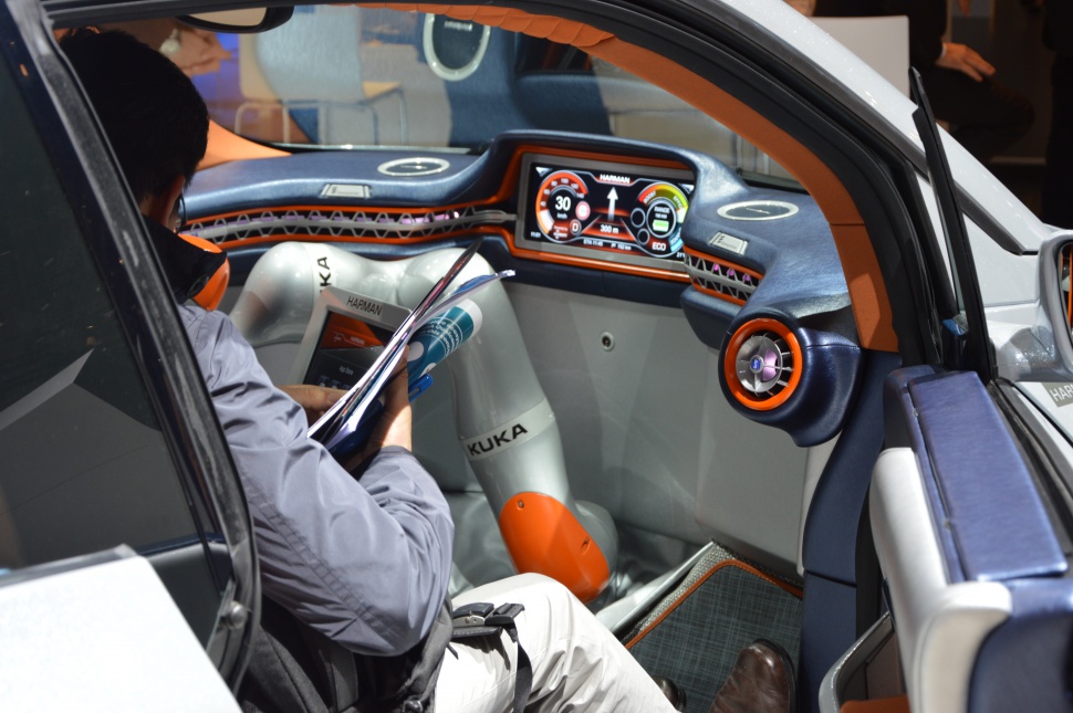 Robotic arm and digital dashboard inside futuristic car interior