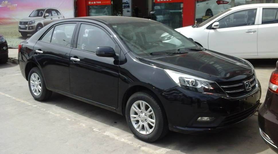 Black sedan with sleek headlights and alloy wheels.
