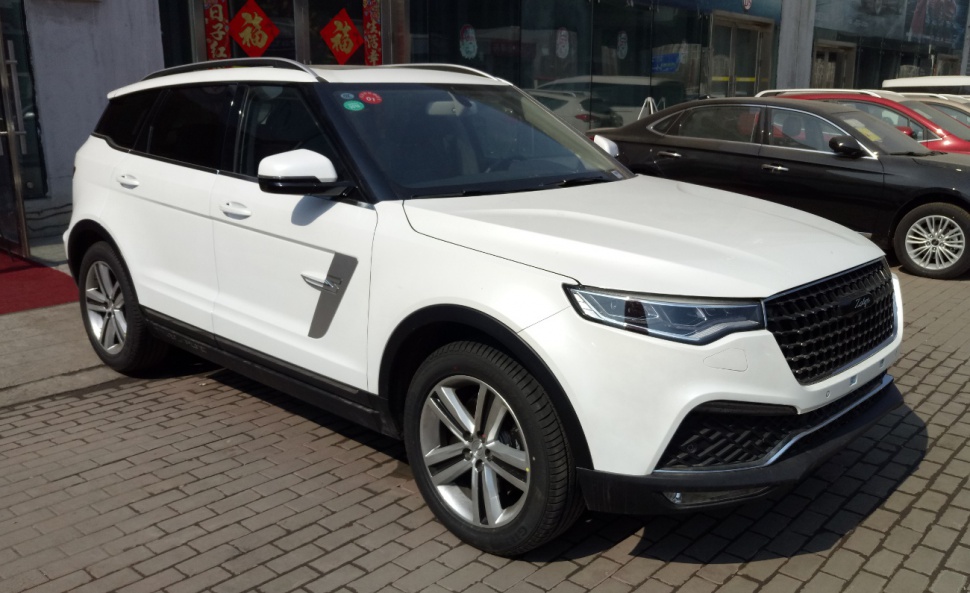 White SUV with modern front grille and sleek side profile
