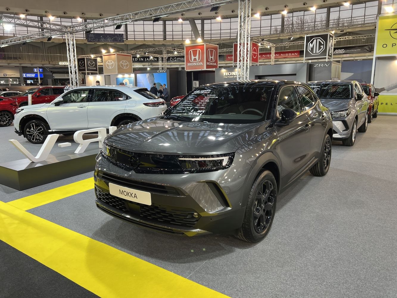 Modern SUV front view with black trim, prominent grille, and alloy wheels.