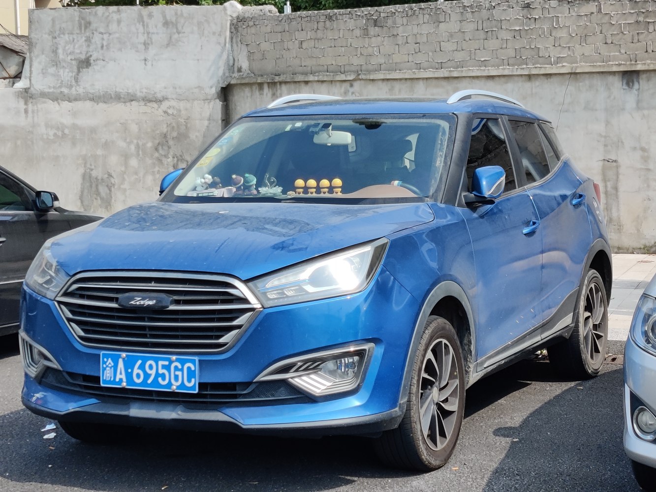 Blue compact crossover SUV with LED headlights and roof rails