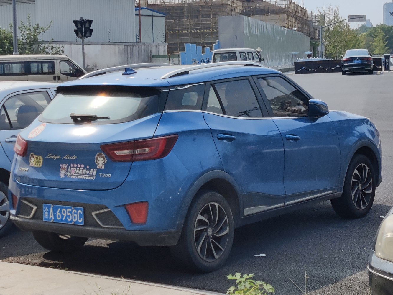 Rear side view of blue compact SUV with sporty taillights and roof rails