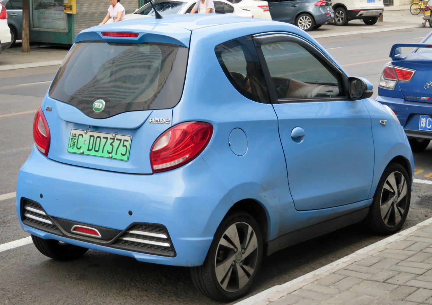 Rear and side view of compact blue electric hatchback with modern taillights and stylish wheels