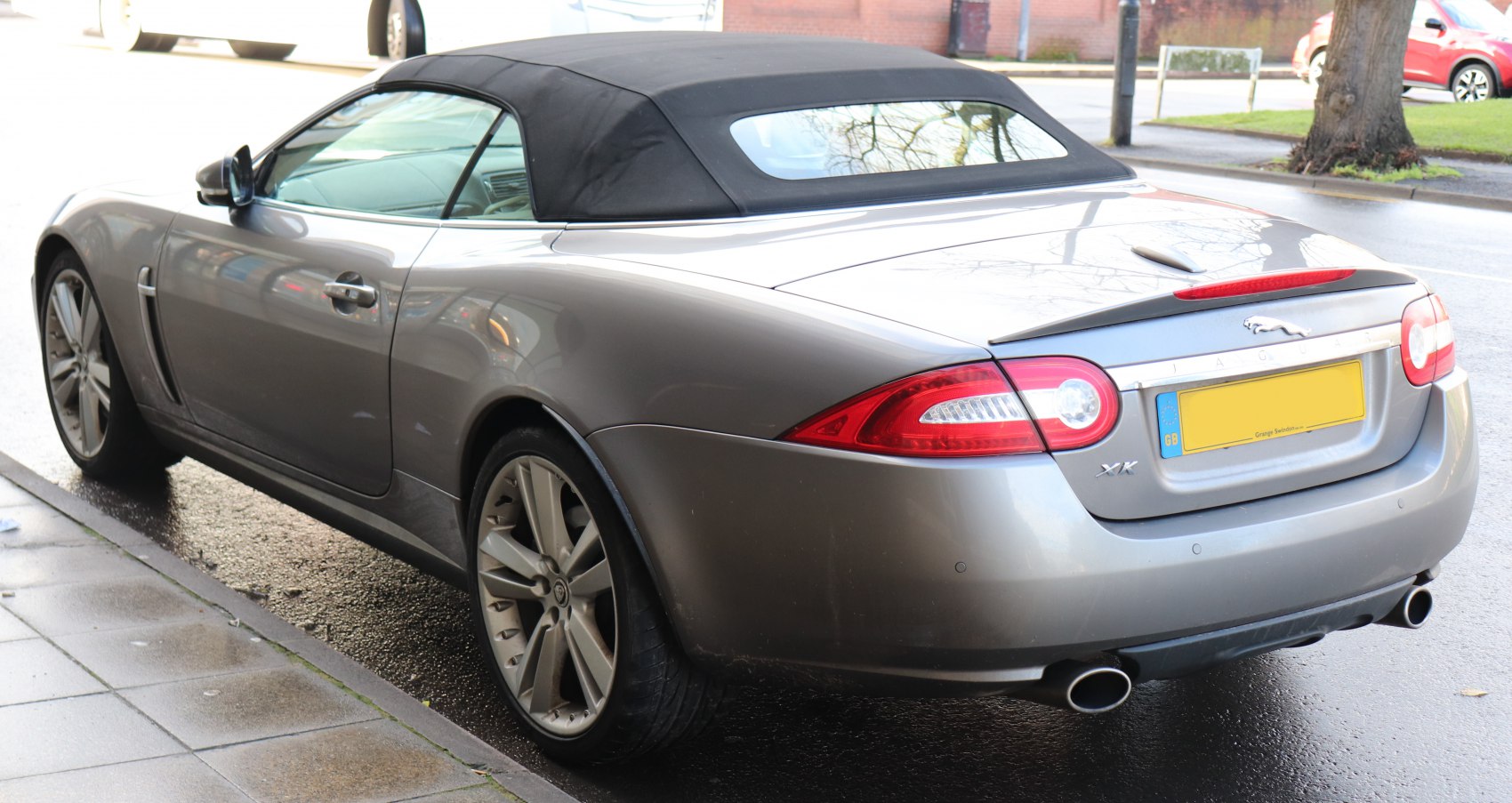 Rear view of convertible with soft top and dual exhausts