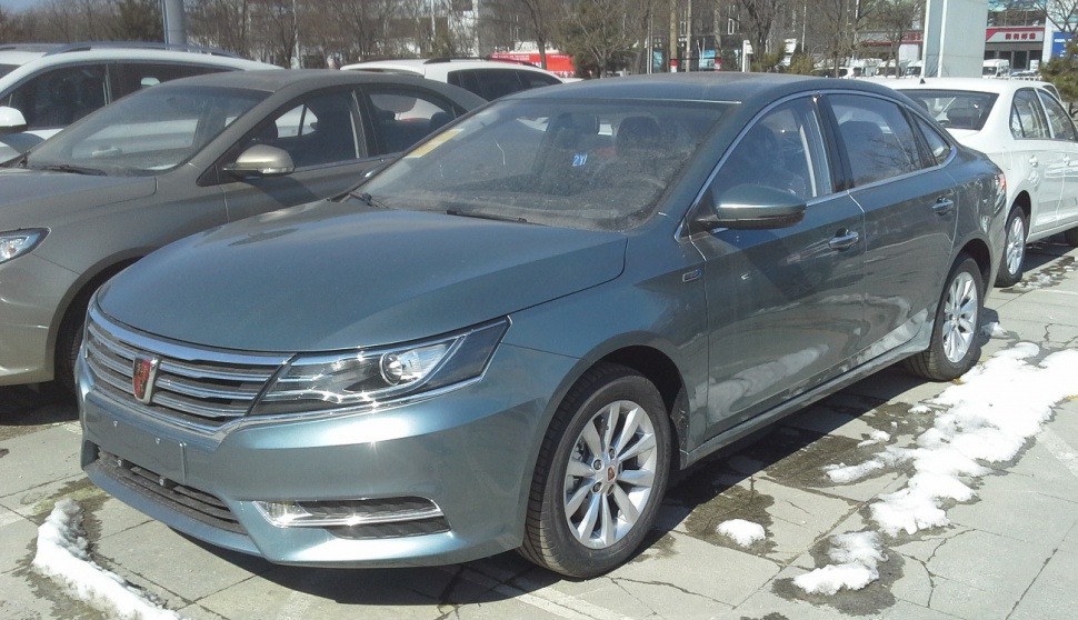 Front and side view of a modern sedan with grille and alloy wheels