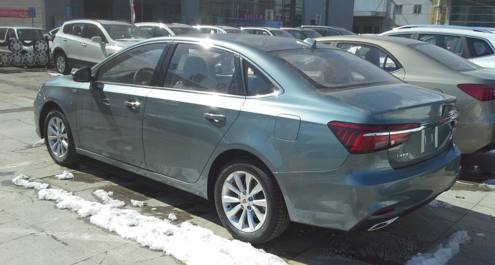 Rear side view of a mid-size sedan with sleek tail lights and alloy wheels.