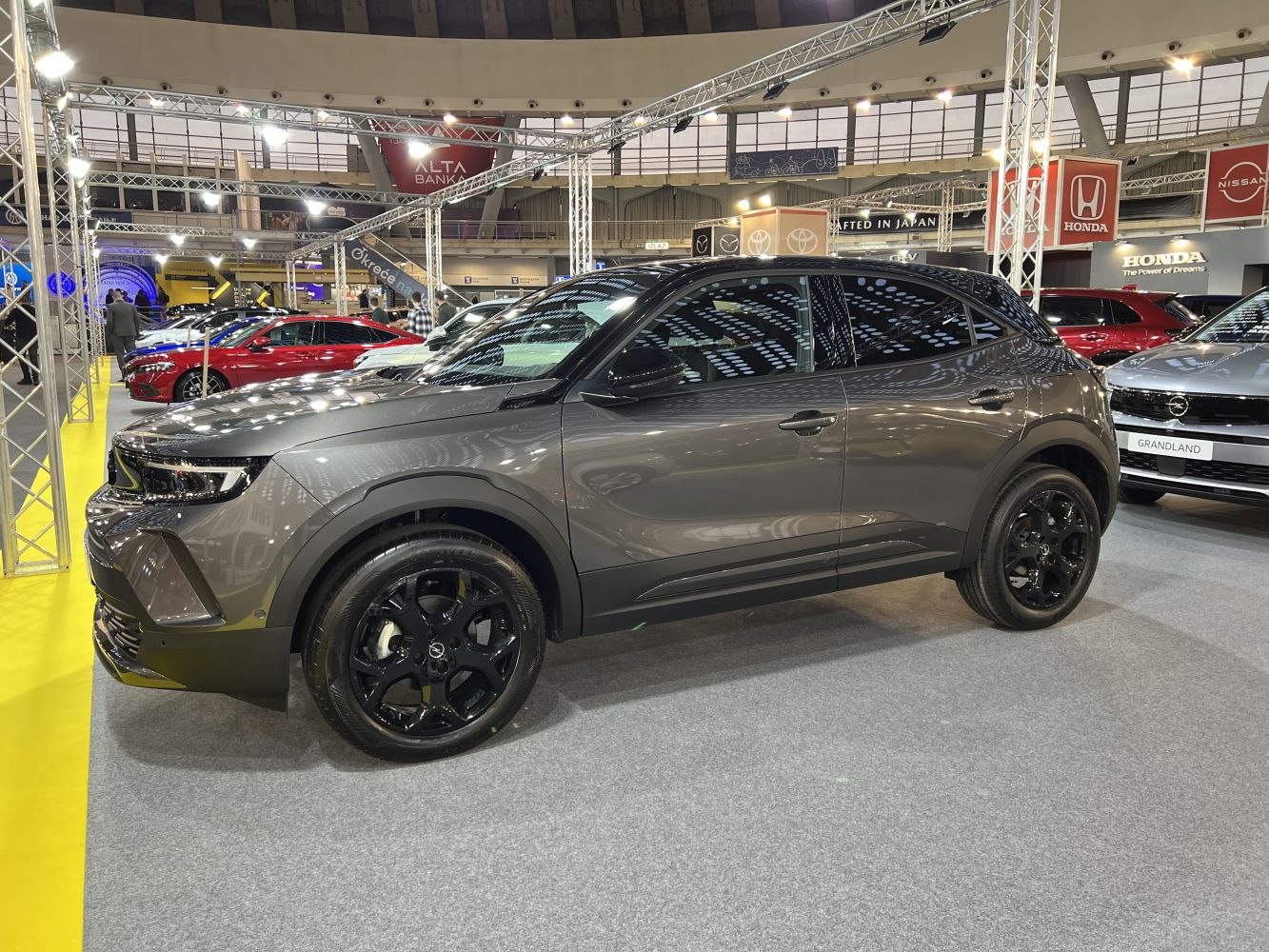 Gray SUV side profile with black alloy wheels