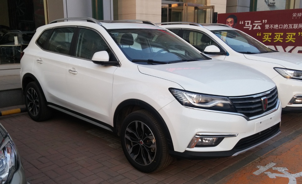 White SUV with sleek grille, alloy wheels, roof rails