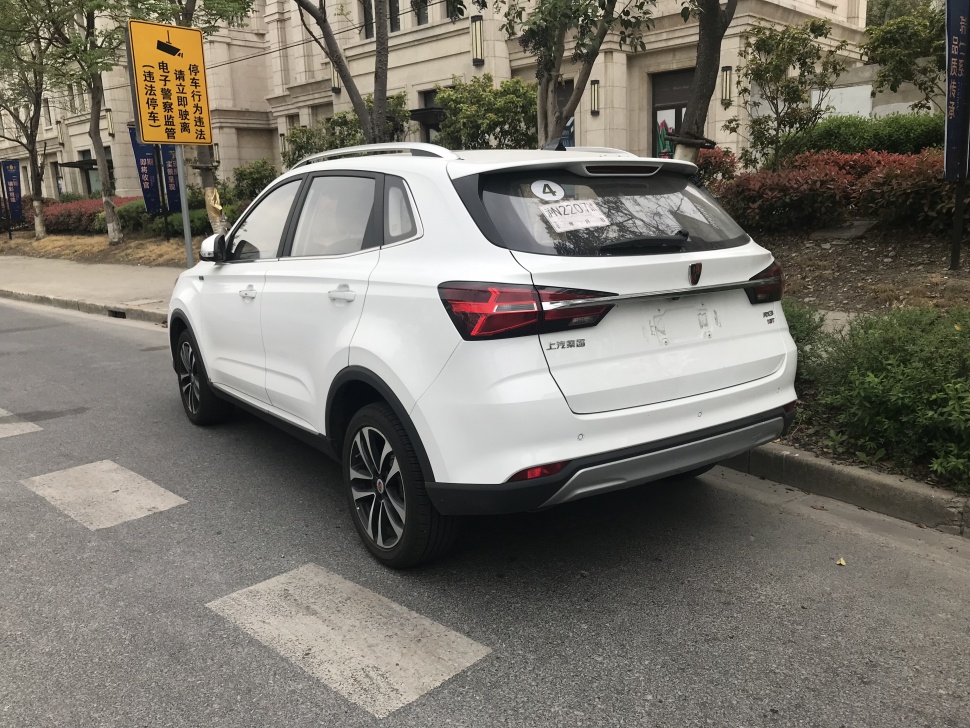 Rear view showing LED tail lights, rear bumper, and rear window details of a white SUV