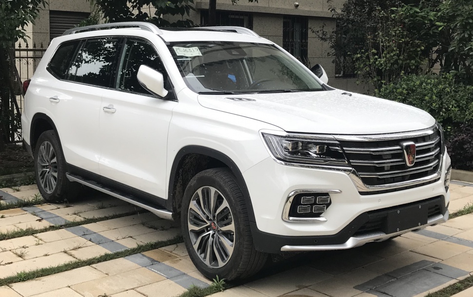 Front side of white SUV with LED headlights and prominent grille