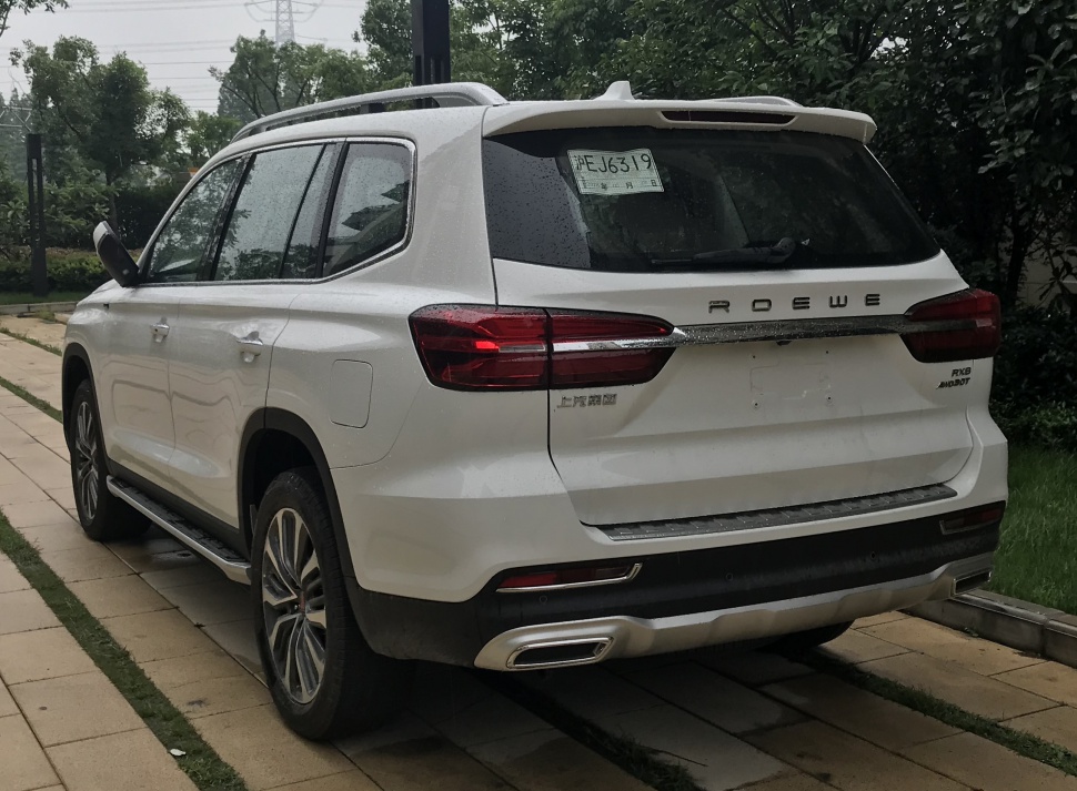 Rear view of SUV with taillights, dual exhaust, and roof spoiler