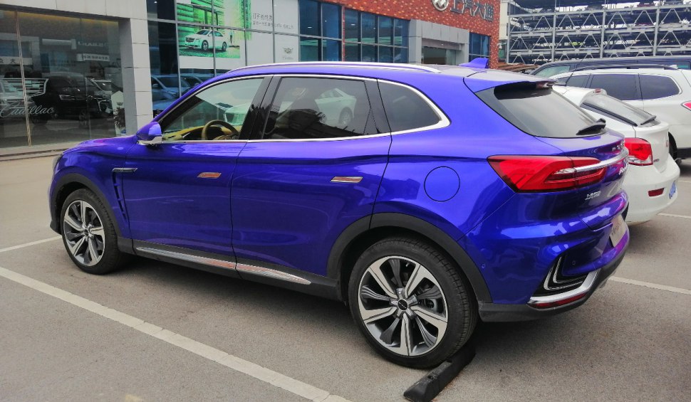 Rear side profile of blue electric SUV with modern design and alloy wheels