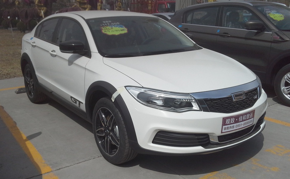 White crossover SUV with black wheels, black trim, and GT badge