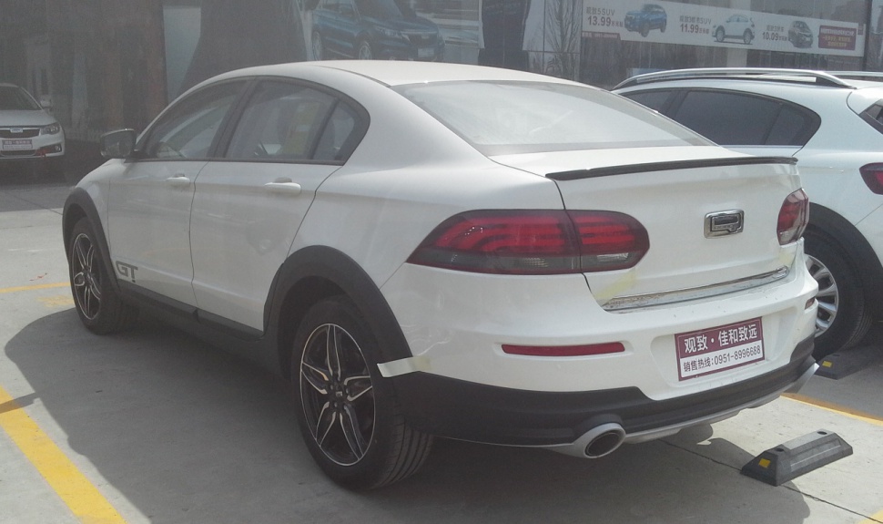 Rear-side perspective with spoiler, LED taillights, alloy wheels, and sporty fender flares