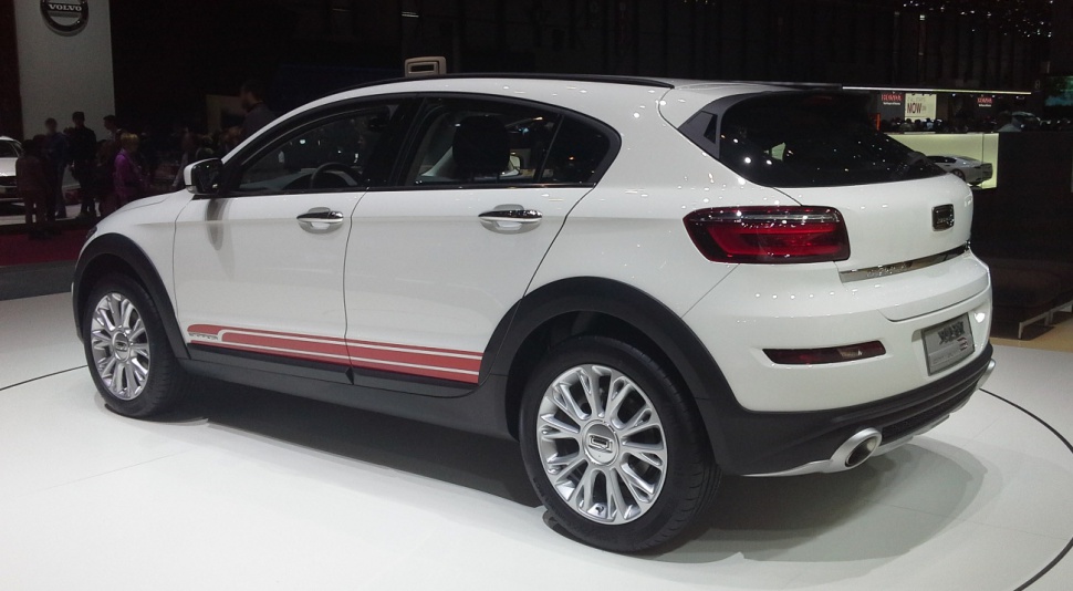 Rear side view of white compact SUV with sporty alloy wheels and red trim decals