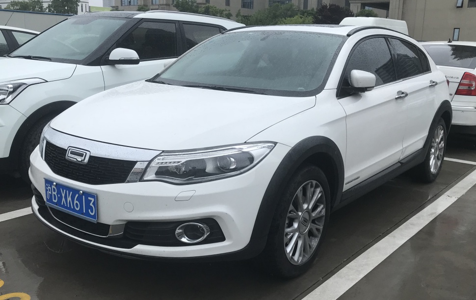 Front-side view of white compact SUV with distinctive headlights and grille