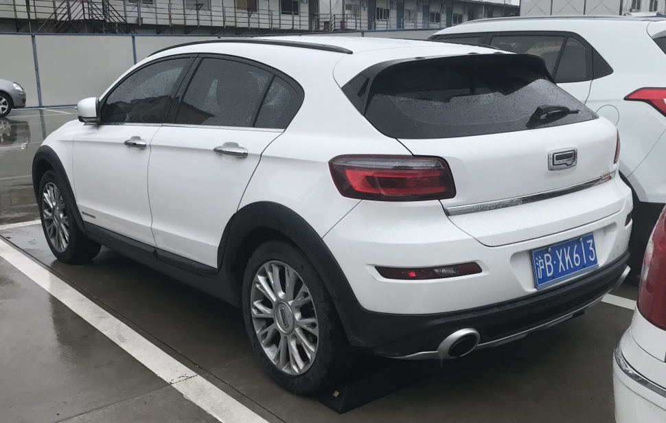 Rear-angle white compact crossover SUV with silver wheels and tinted windows.