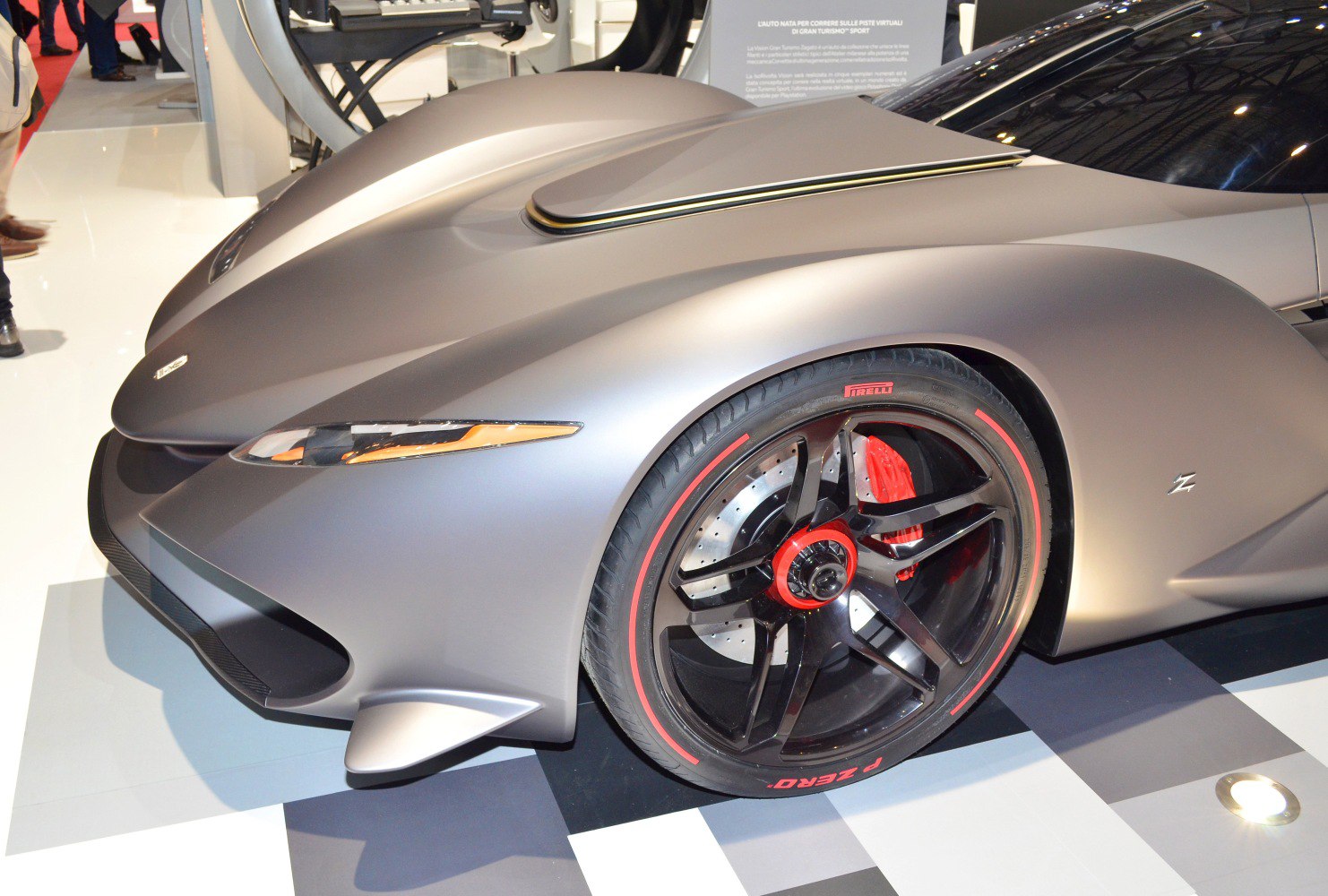 Aerodynamic front design with sleek headlights and sporty wheel with red accents