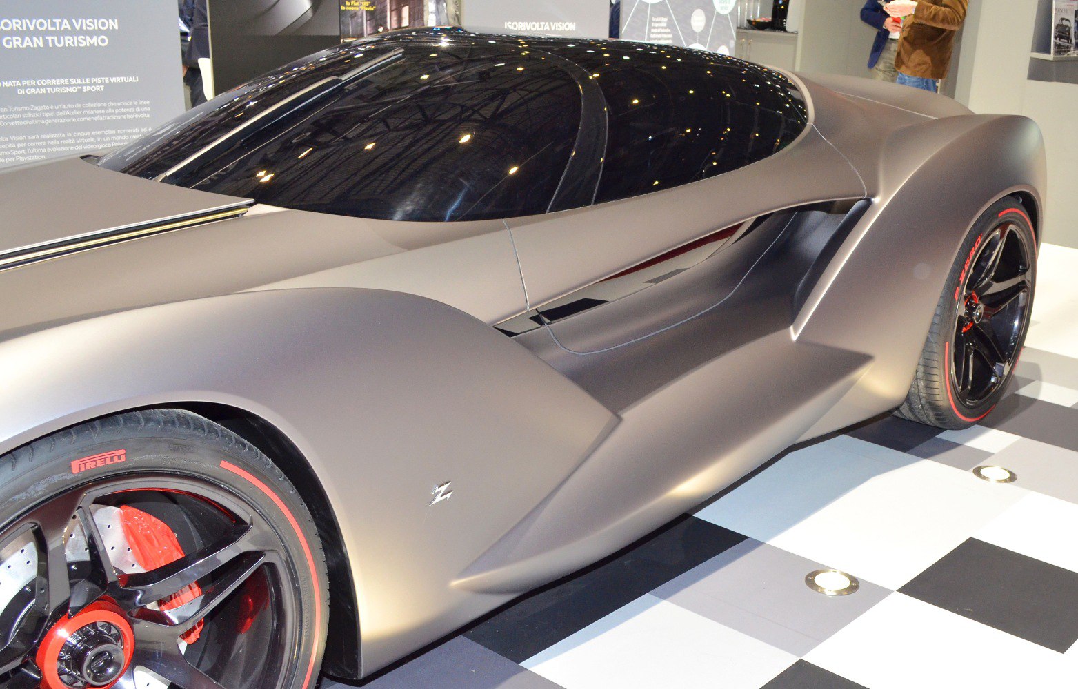 Sleek aerodynamic side profile with black alloy wheels and red accents