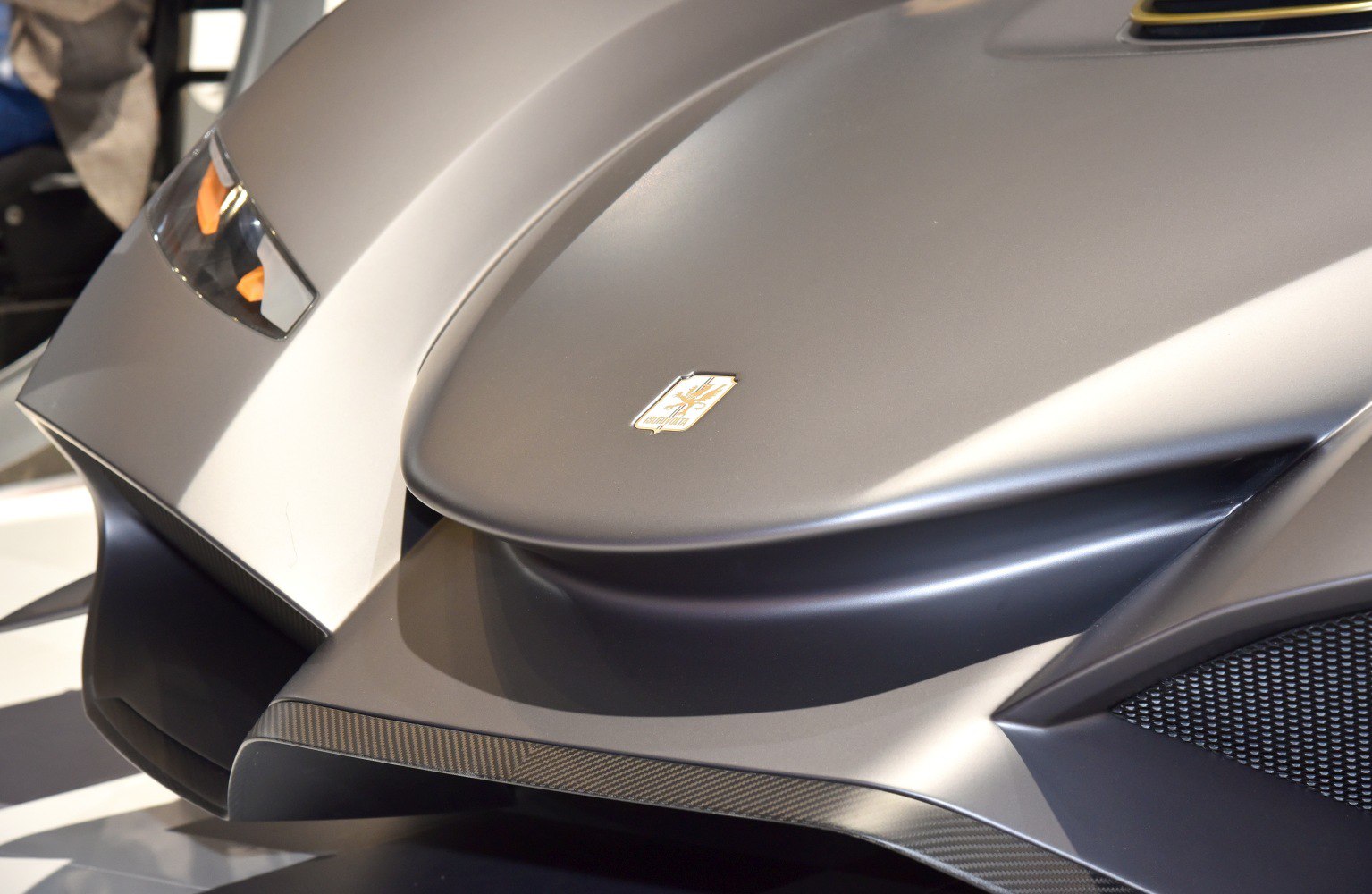Close-up of aerodynamic front hood and headlight design.