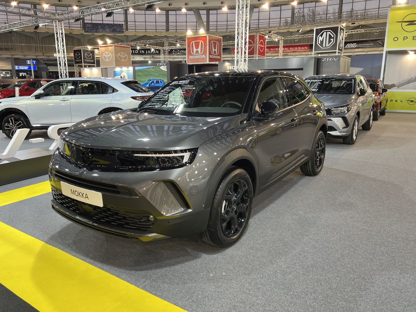 Gray SUV with LED headlights and black alloy wheels, front and side view