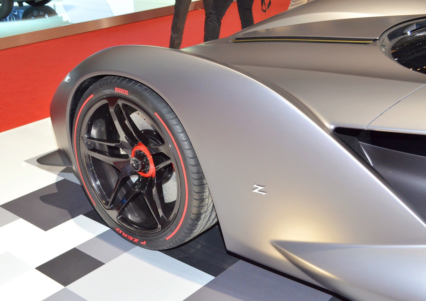 Matte black aerodynamic fender with black and red accented wheel close-up