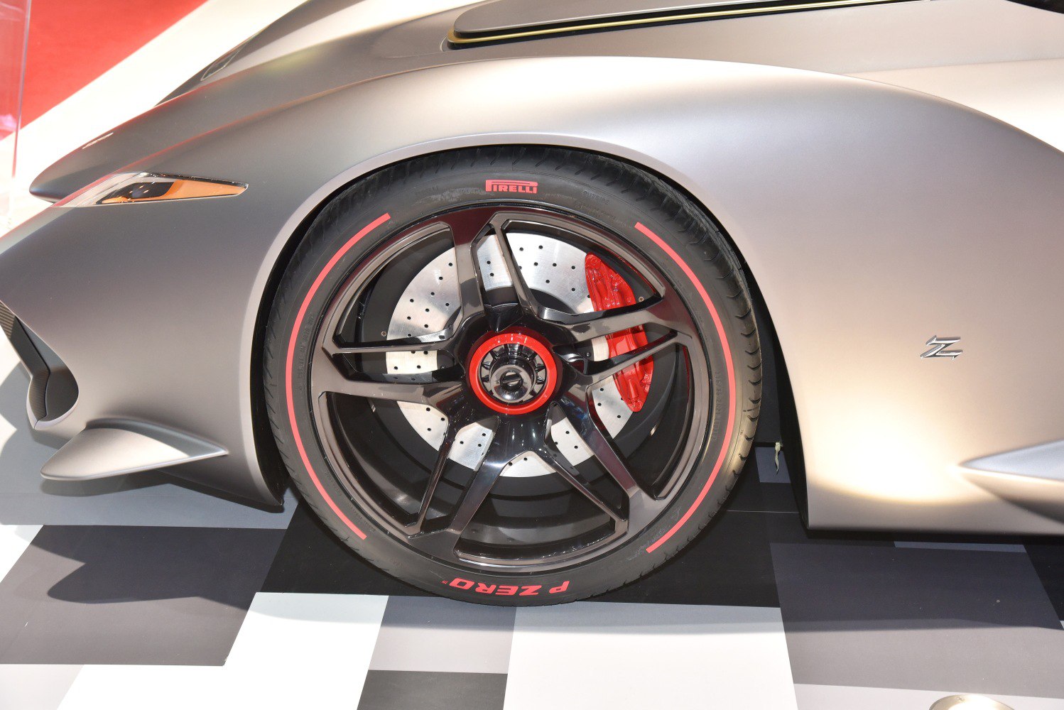 Close-up of sporty wheel with red brake caliper and Pirelli tire
