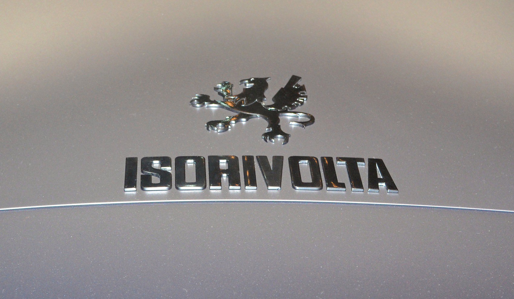 Close-up of IsoRivolta emblem and badge on a silver metallic surface