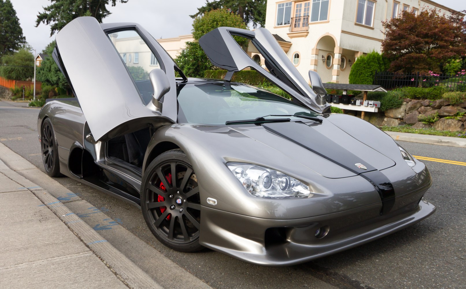 Supercar with open upward dihedral doors and aerodynamic front design