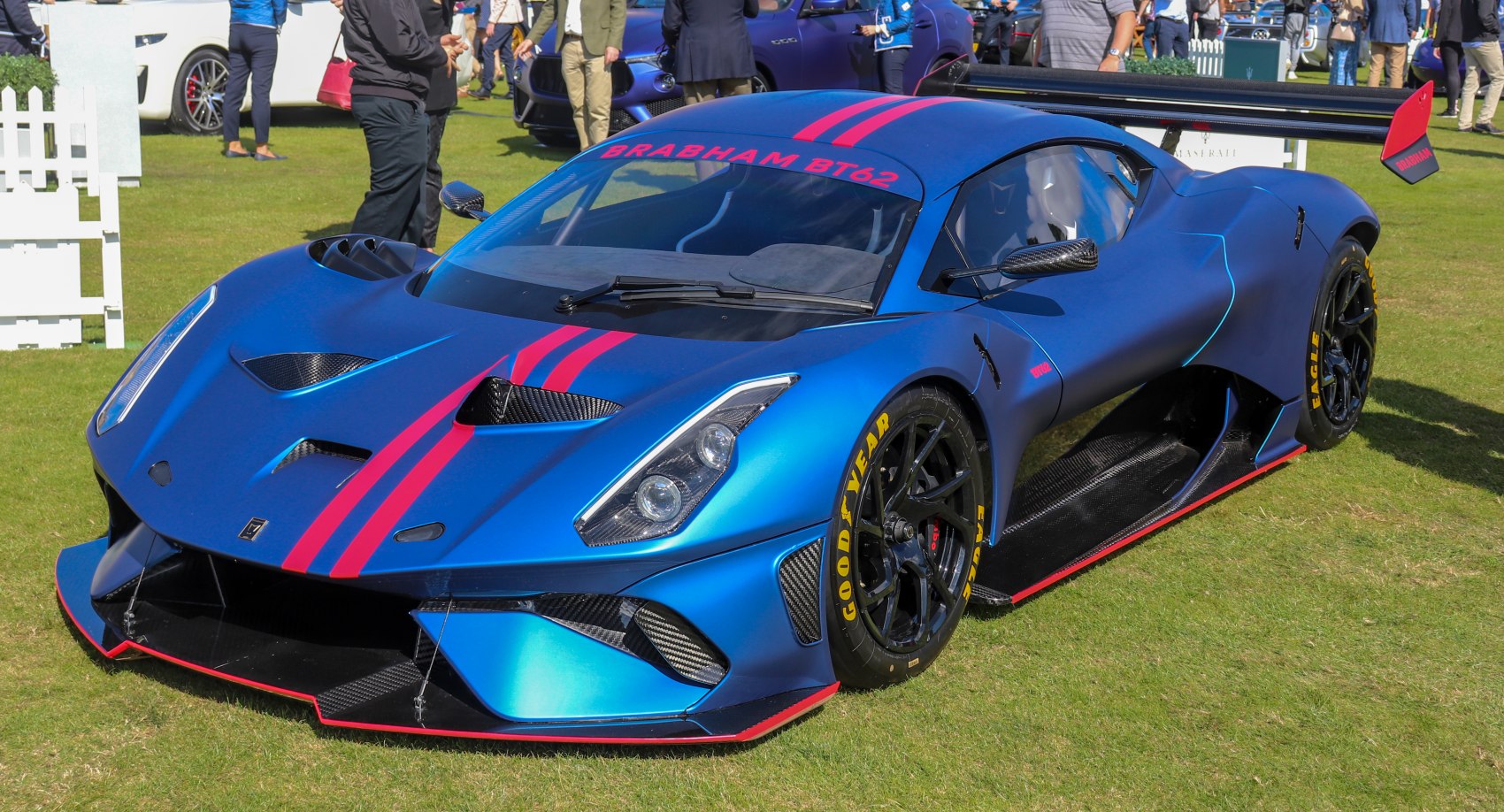 Blue Brabham BT62 race car with aerodynamic features and pink racing stripes