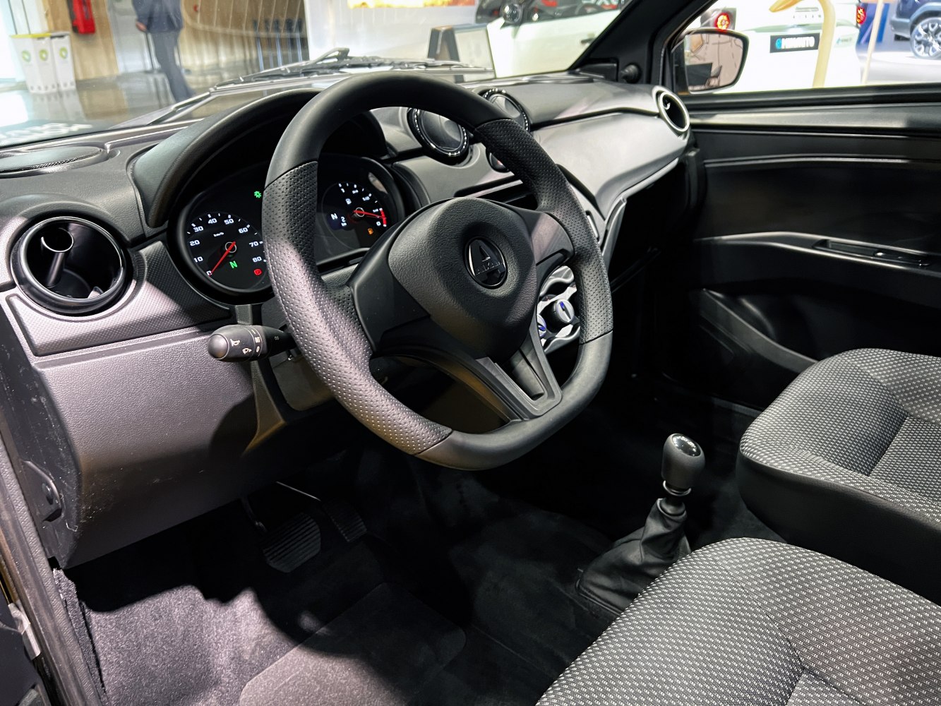 Compact vehicle interior with manual gearshift and analog gauges