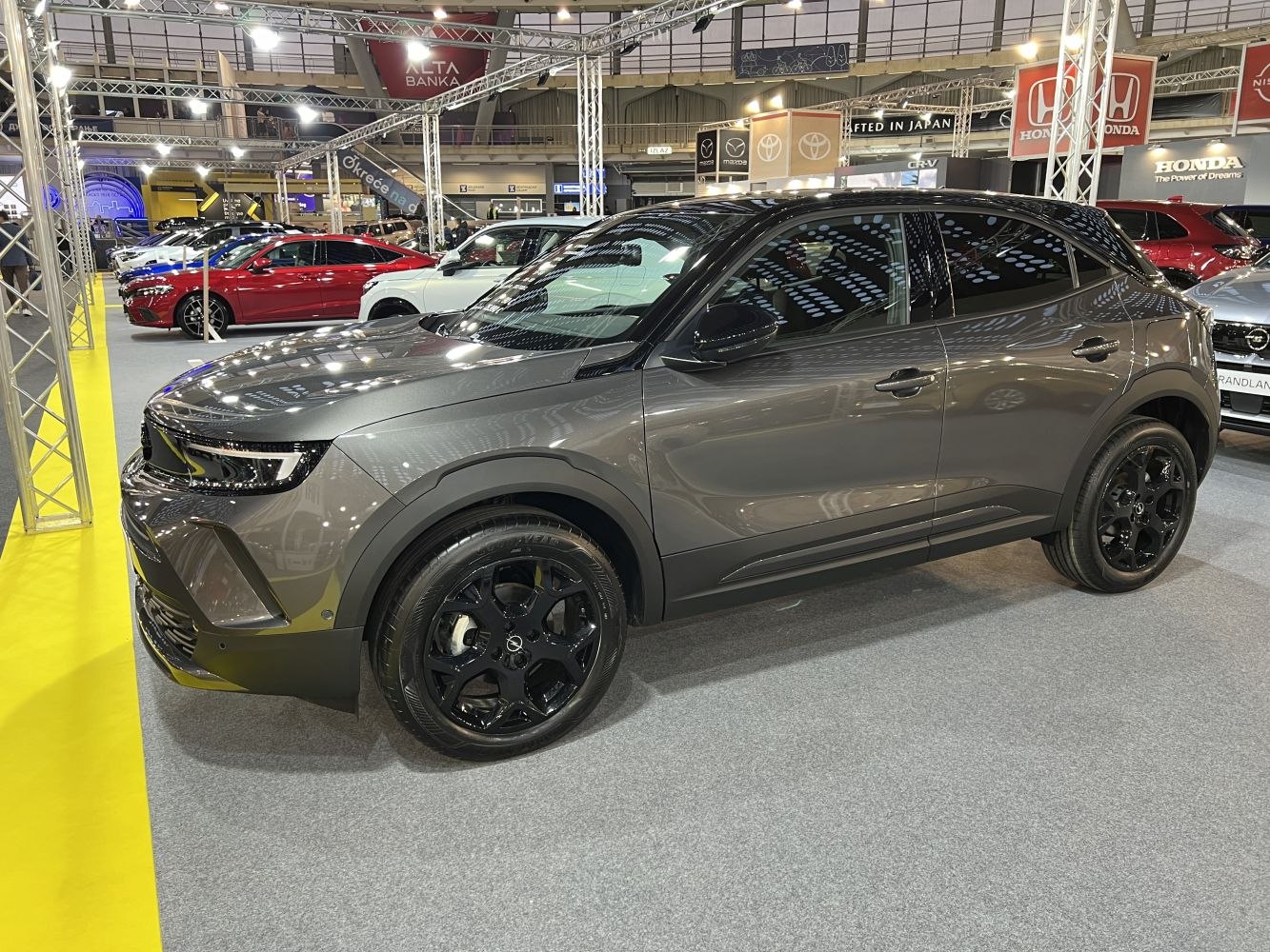 Side profile of a compact SUV with black alloy wheels
