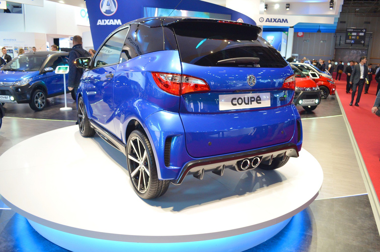 Rear view with dual exhaust and black roof of a microcar