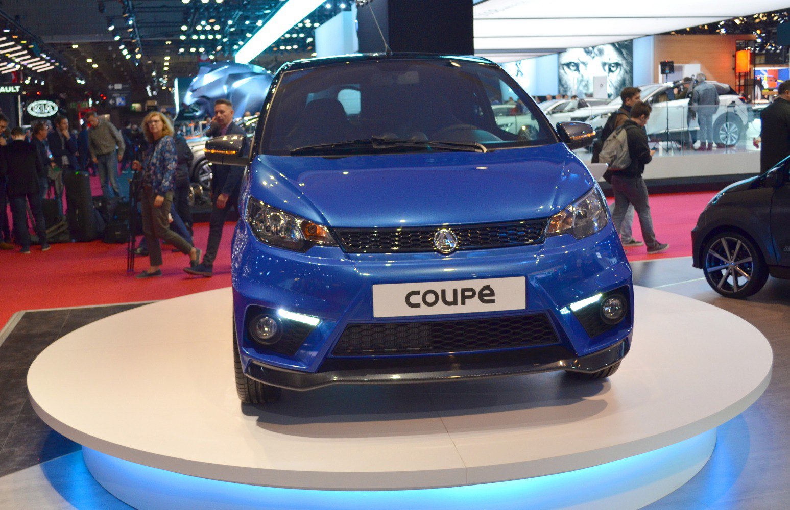 Front view with LED daytime running lights and sporty grille on compact coupe.