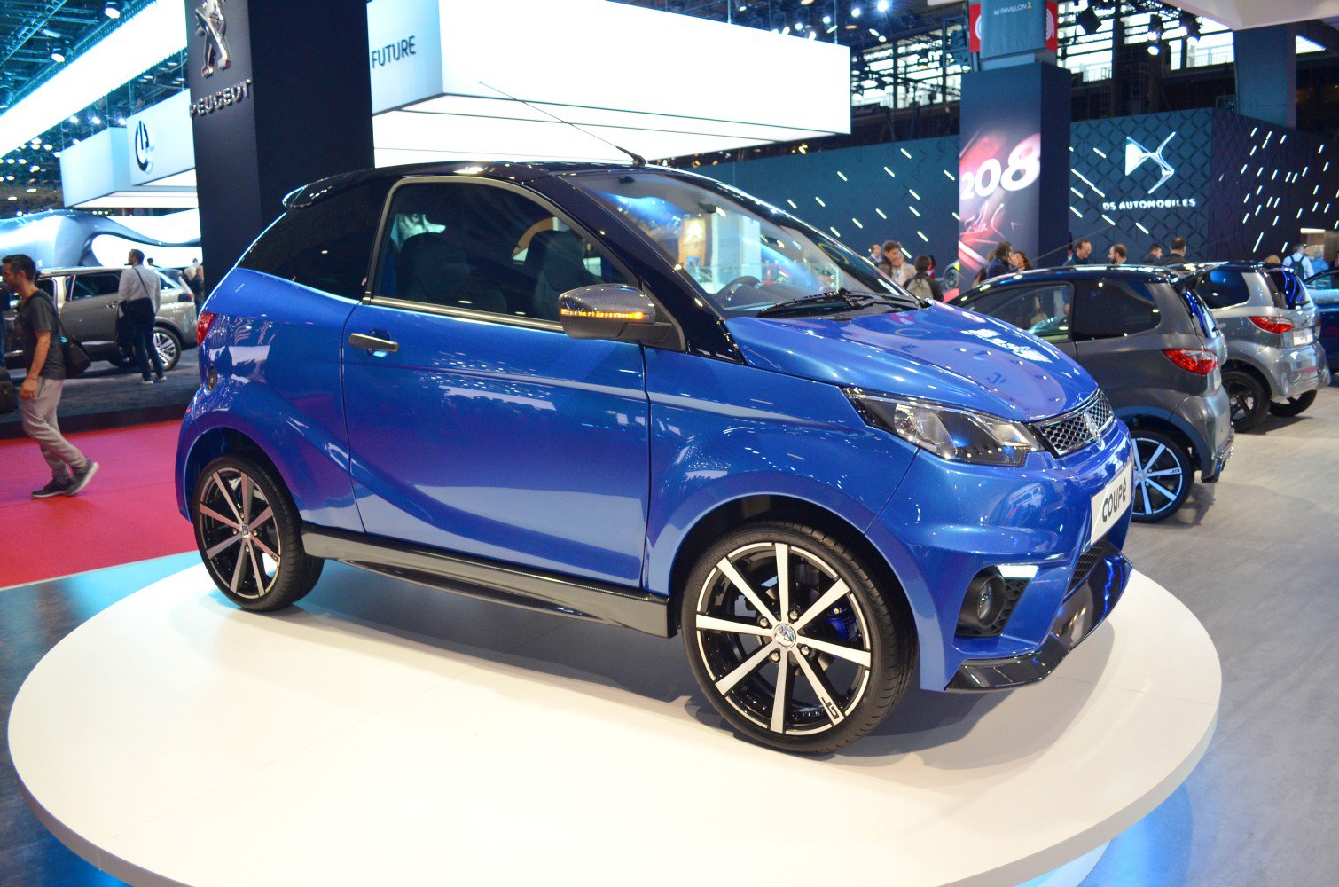 Two-door microcar coupe with black roof and alloy wheels
