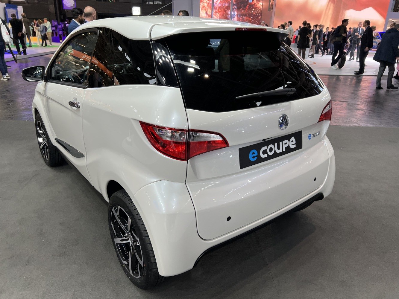 Compact electric microcar rear with coupe styling and black glass roof