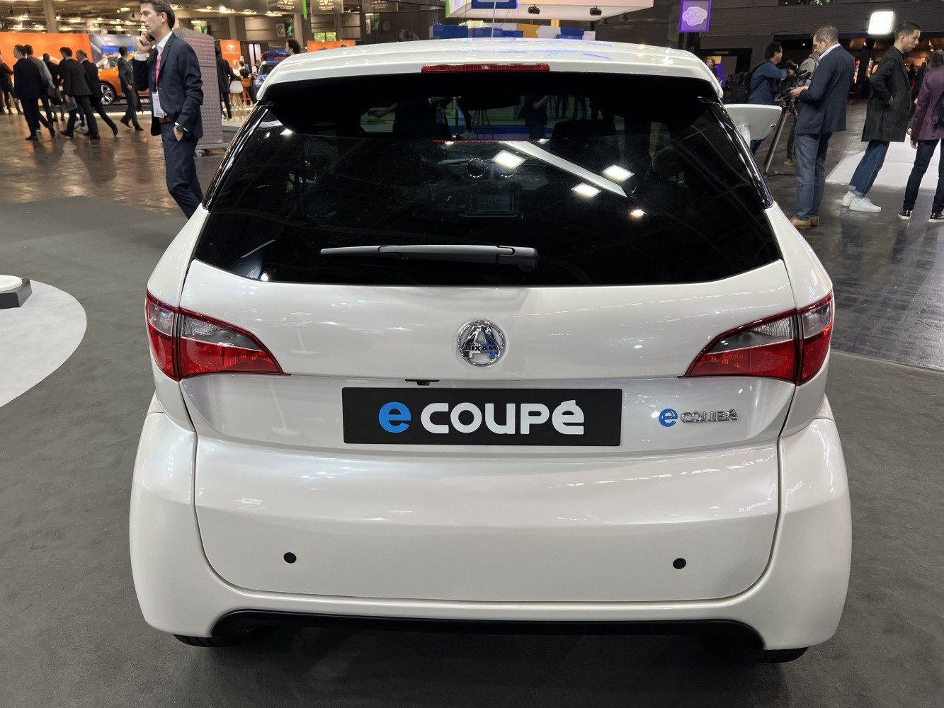 Rear view with taillights, rear windshield wiper, and car badge