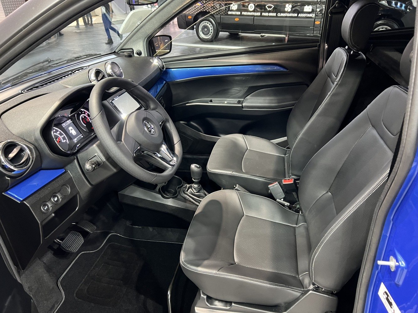 Black leather seats and manual transmission interior with blue trim