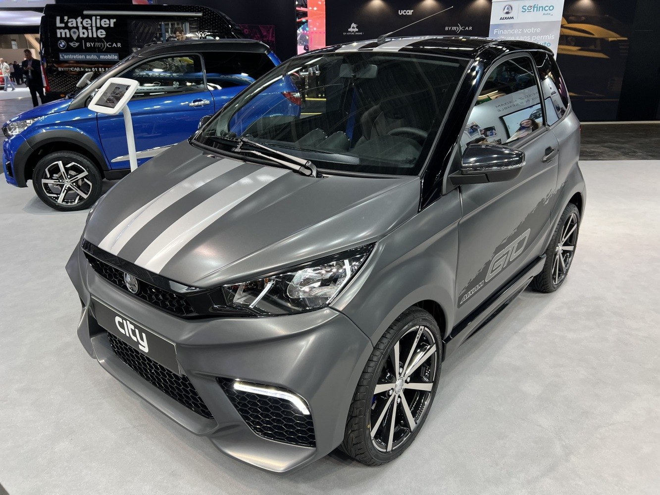 Sporty microcar with racing stripes and aggressive front fascia