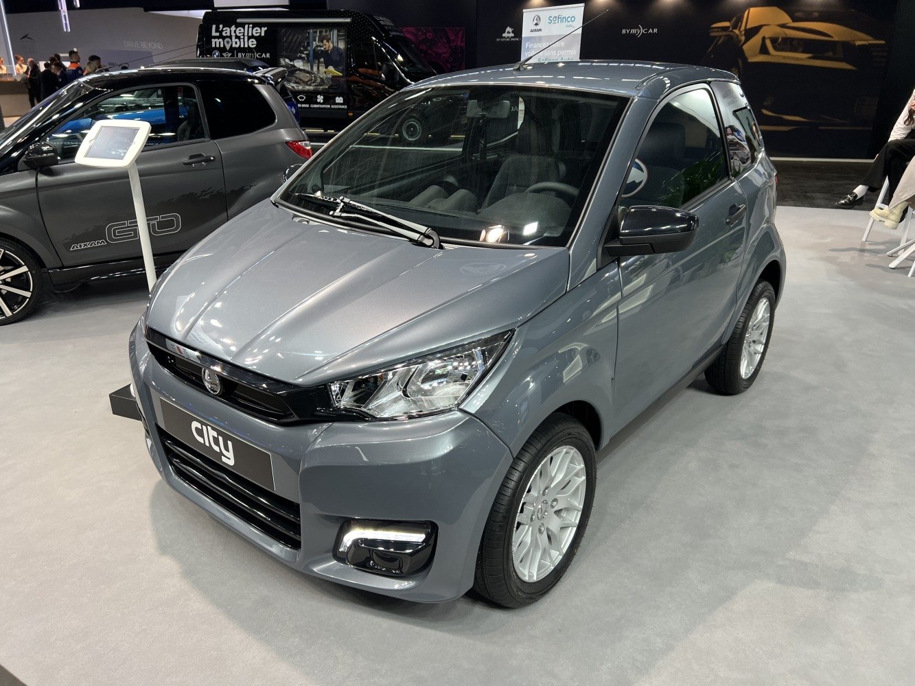 Compact microcar with modern LED headlights and sporty alloy wheels