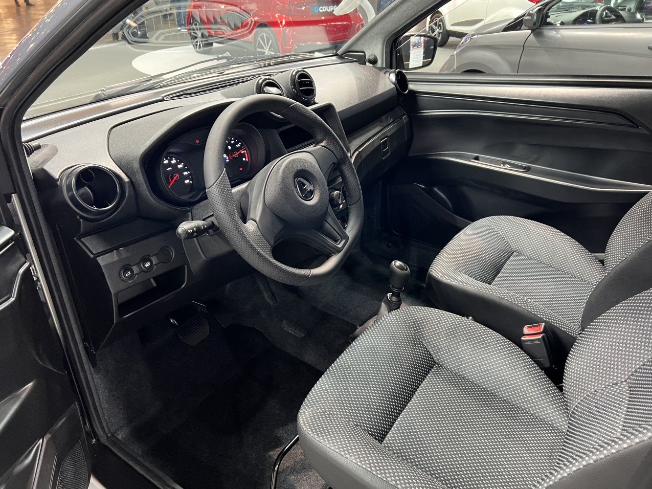 Steering wheel, dashboard, and front seating interior of a small vehicle